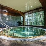 Big luxury hot thub in hotel spa green area, copyspace